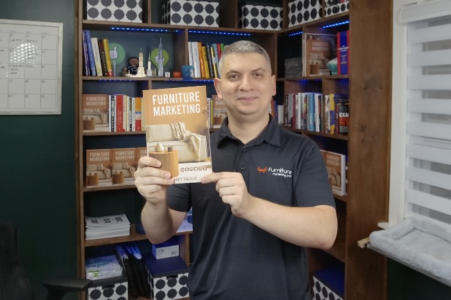 Ahmet Yavuz, founder of Furniture Marketing Pros, holding the Furniture Marketing book